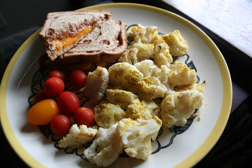 On Cinnamon-Raisin Swirl bread with a side of cherry tomatoes, cauliflower baked with s&p + nutritional yeast