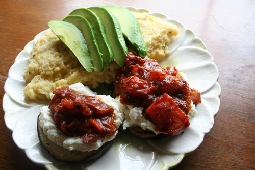 "Eggplant dripping with a tomato and ricotta salsa" served with basil polenta, and avocado.